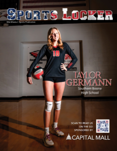 female student athlete holding volleyball in high school gym